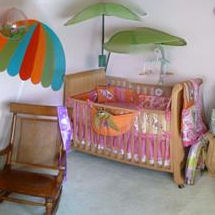 Surfer girl baby nursery with beach theme crib bedding and decor