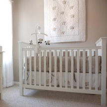 Baby girl taupe and white nursery with a Pottery Barn Kendall crib and dresser