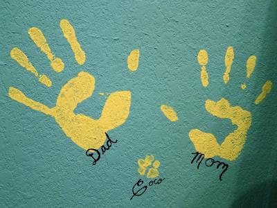 Handprints Left by Mommy, Daddy and a Puppy Dog Paw Print on the Nursery Wall.