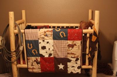 Rustic western baby crib that we made, cabin style, from pine logs for our little cowboy