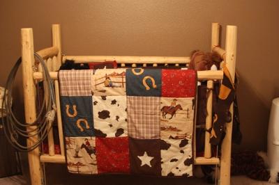 Rustic homemade baby crib that we made from pine logs