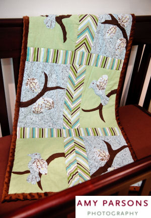 Homemade patchwork bird theme baby crib quilt with appliques and chevon stripes border