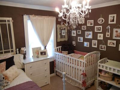 A gallery picture wall in a chocolate brown baby girl shabby chic nursery made of vintage photo frames in many sizes