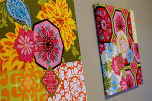 Brightly colored homemade fabric wall art squares for a baby girl's nursery