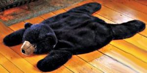 Fake bear skin rug for the rustic log hunting lodge themed nursery room