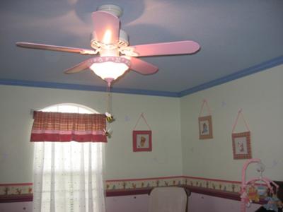 Our classic Winnie the Pooh nursery theme features a sky blue ceiling with clouds and our baby girl's pink ceiling fan.  