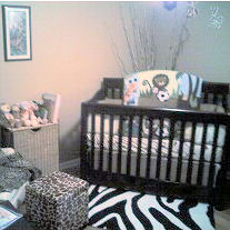 A baby nursery with a zebra print rug in front of the crib