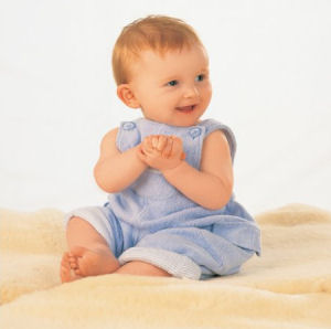 Real unshorn baby sheepskin rug used as a baby portrait photo prop