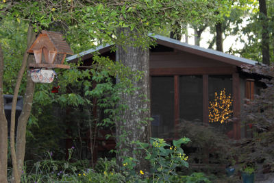 Screened in porch on a special house in the back yard where the BBQ chef can grill