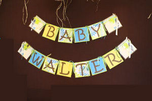 Homemade beach theme baby shower banner for a baby boy made from tropical print paper