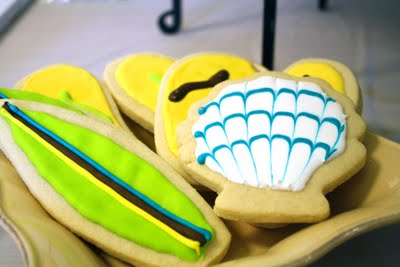 Beach theme seashell and surfboard decorated baby shower sugar cookies