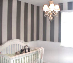 Baby girl nursery walls with a brown and pink paint color scheme and stripes painting technique