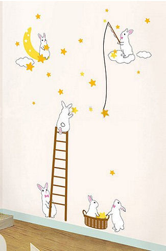 Cute bunny rabbit wall decals and stickers in a neutral yellow pink and white moon and stars theme baby nursery