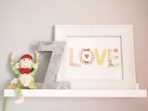 neutral gray nursery wall letter frame ledge arrangement