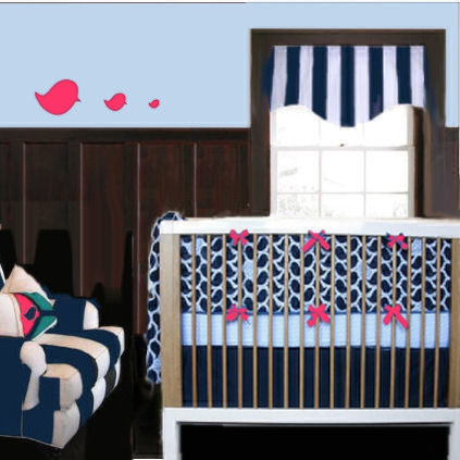 Black and white stripes in a baby girl nursery room with hot pink bird wall decals and bows on the crib