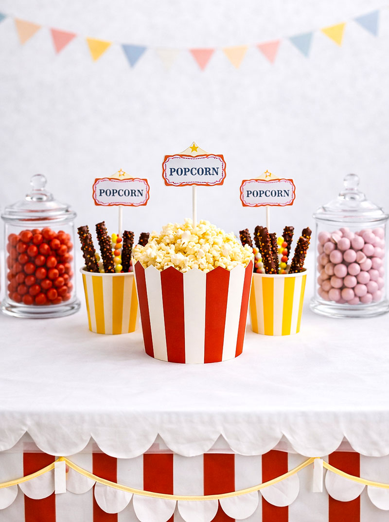 Circus baby shower centerpiece with popcorn containers and candy display