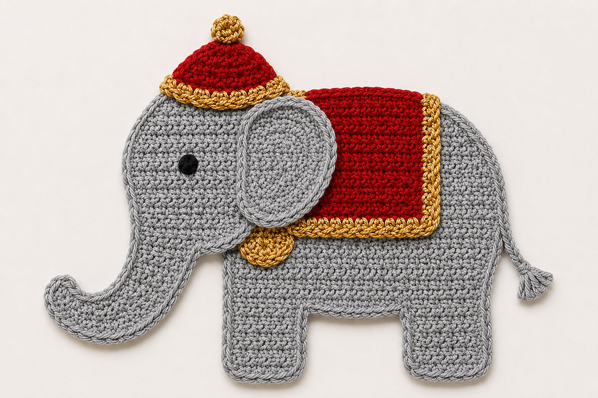 Crochet circus elephant applique pieces with a rust red saddle blanket gold trim and matching circus hat