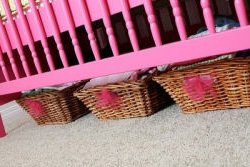 Baby crib painted hot pink using spray paint in a baby girl pink and green nursery room