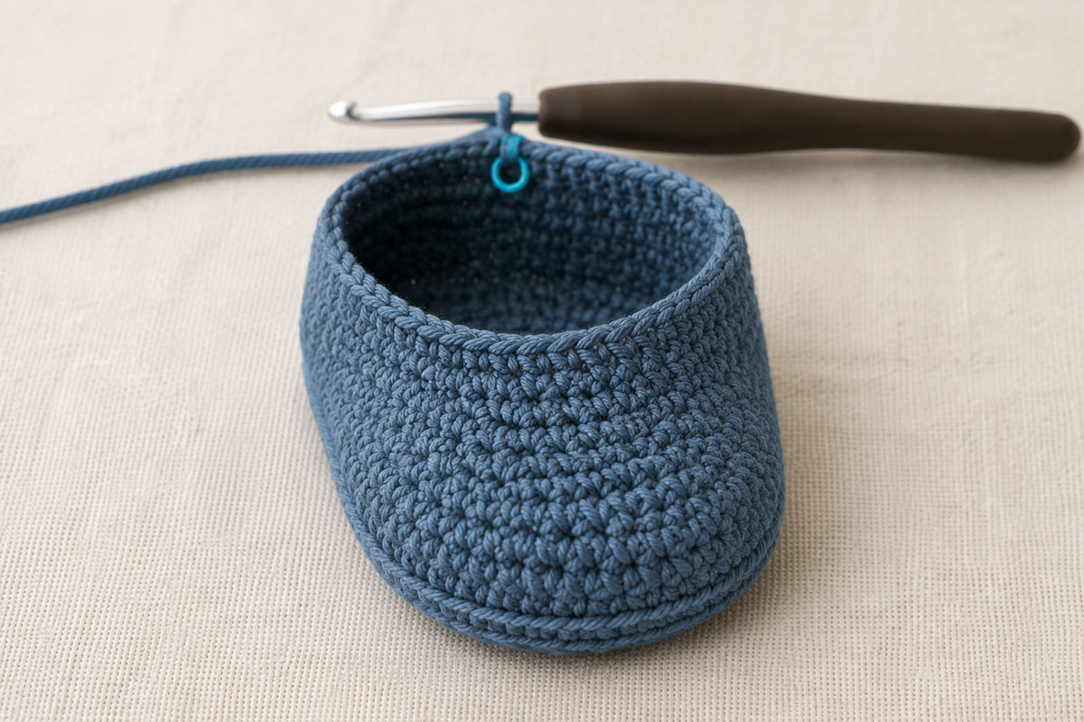 Centered half double crochet decreases shaping the closed toe of a baby bootie