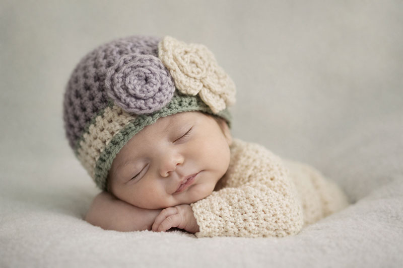 Purple, forest green and cream newborn baby girl chunky yarn baby beanie hat with large crochet flower pattern photo prop studio portrait