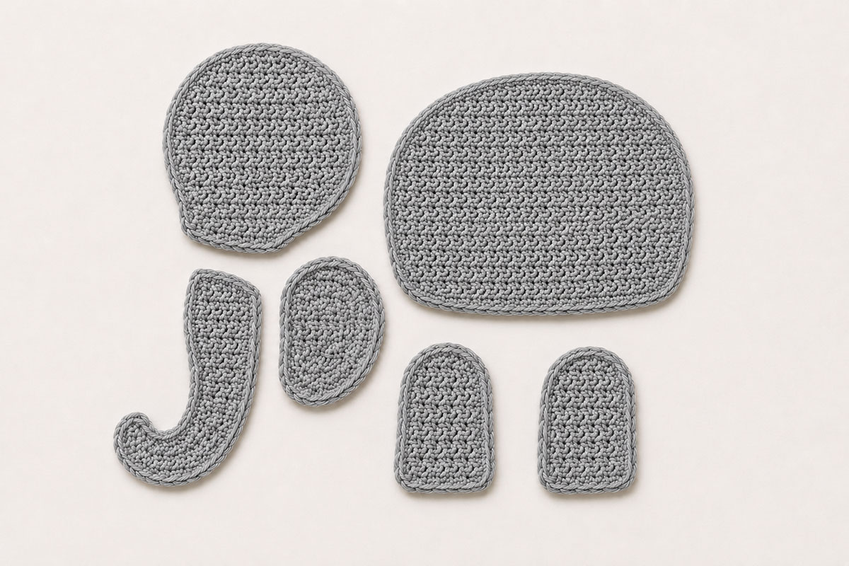 Flat gray crochet pieces for the circus elephant applique including body head ear trunk and two legs