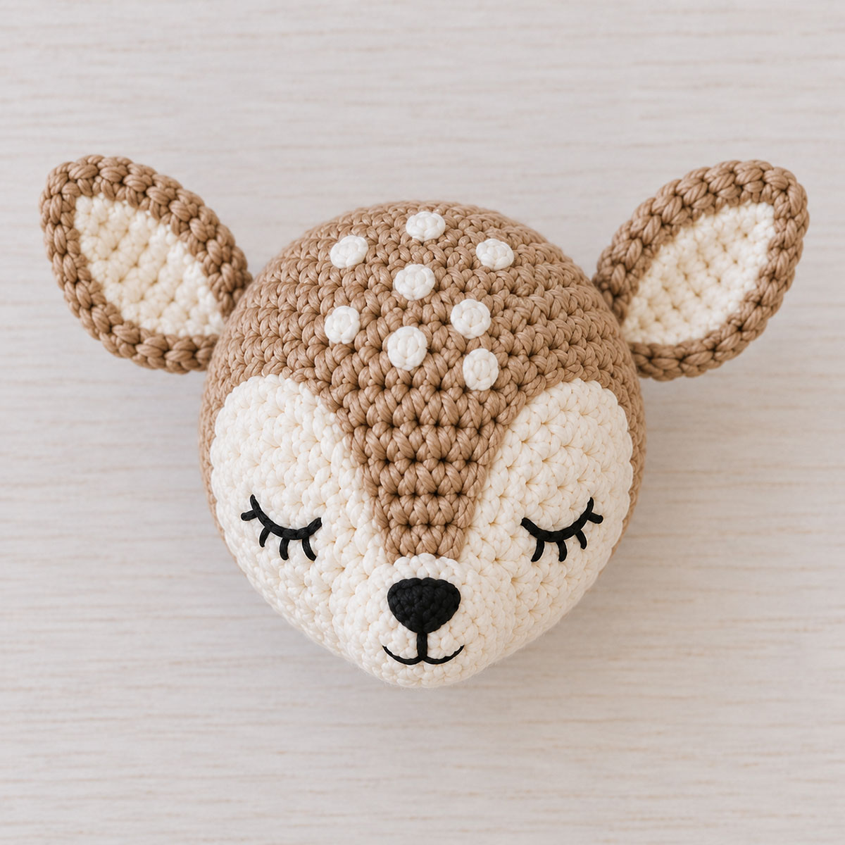 Finished crochet fawn head with two cream face panels, five forehead spots, layered ears and embroidered sleepy eyes
