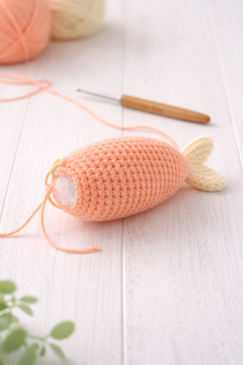 Crochet fish body in progress showing shaping before the fins are attached