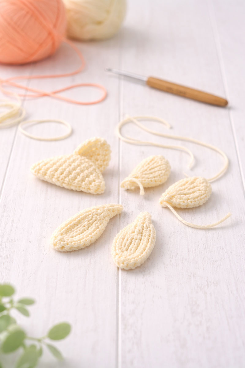 Finished crochet fish fins and tail pieces arranged before assembly