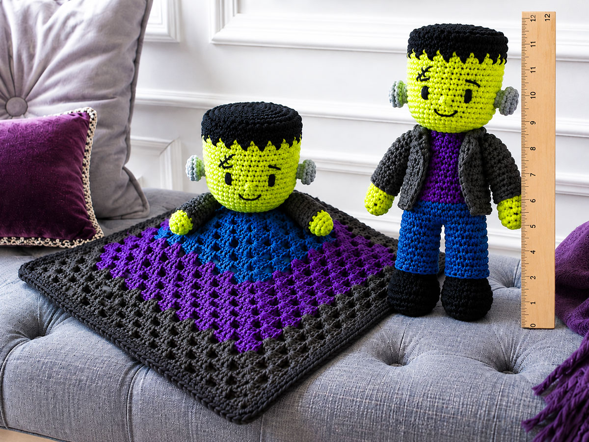 Finished crochet Frankenstein monster doll beside a flat baby lovey with a 12-inch ruler showing the doll height