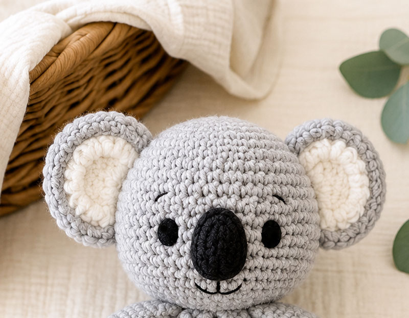 crochet koala lovey pattern head detail showing round gray head wide ears and embroidered face