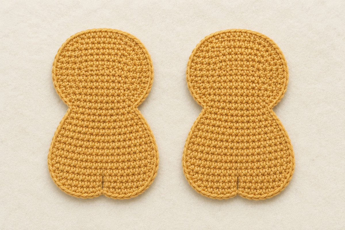 Two matching golden tan crochet lion applique body panels showing the shaped body neck and rounded head before assembly