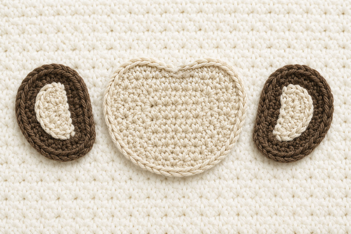 Two brown crochet monkey ears with cream inner ear patches beside the cream monkey face patch before assembly