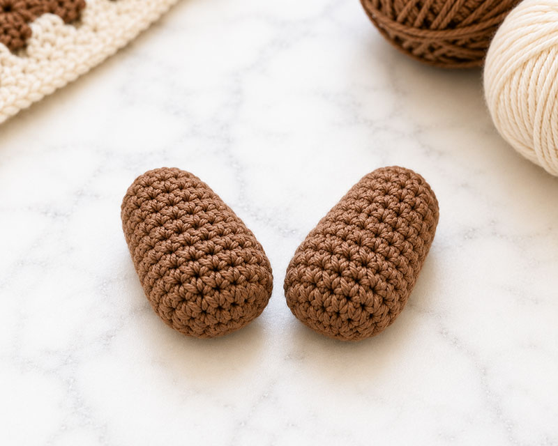 Finished crochet otter lovey paws before assembly