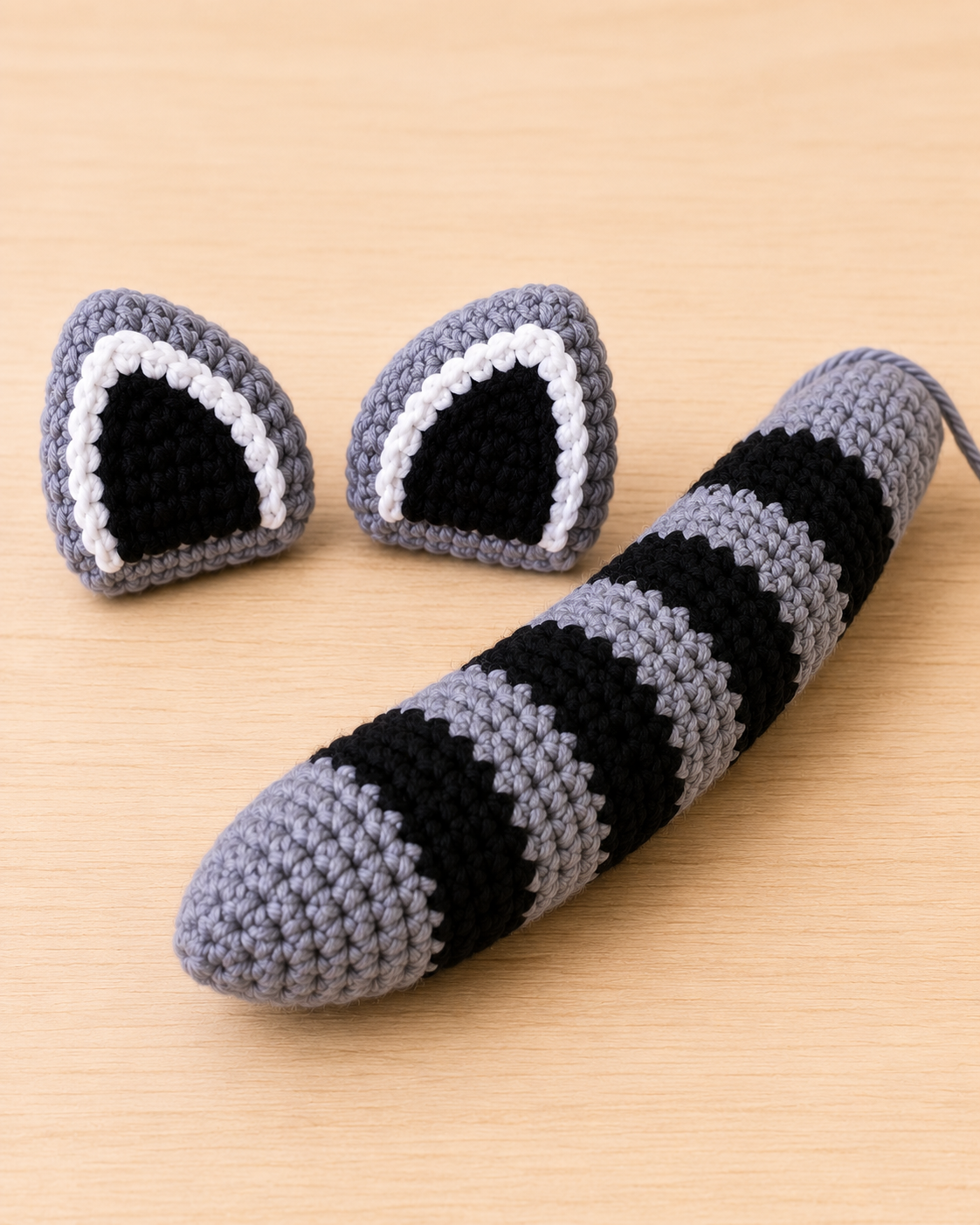 Crochet raccoon pointed ears with black centers white trim and striped tail