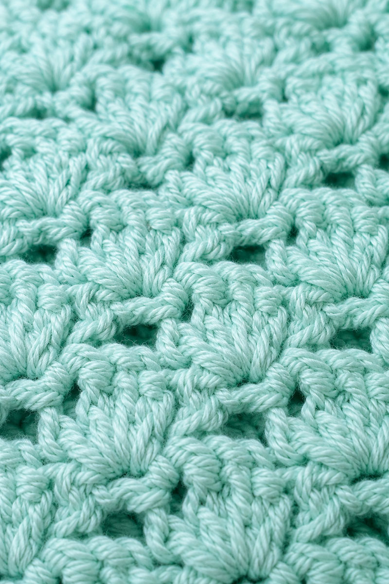 Close view of seafoam crochet stitches on a handmade seahorse lovey blanket