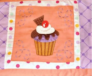 Cupcake crib bedding set with appliqued quilt and 3D applique