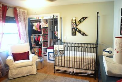 Chris and Kara's baby girl, Kara's, nursery.  The  nursery's color scheme is blue, gray and white with dark pink accent pieces.  