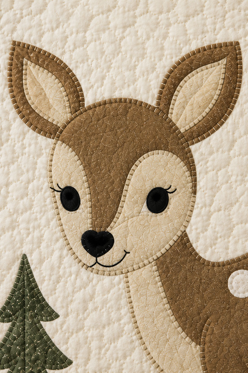 Close view of deer baby quilt pattern appliqué showing facial features and spot placement