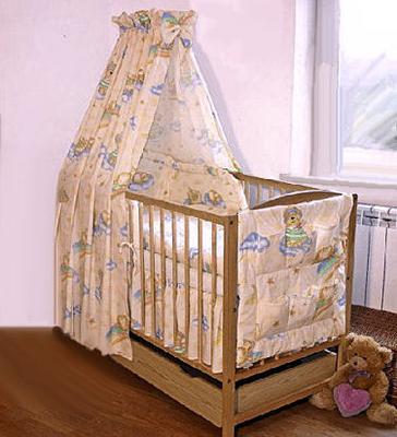 A blue and yellow custom baby bedding set with a crib canopy sewn from fabric with a teddy bear and clouds pattern for a baby boy nursery room.