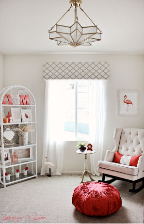 A modern nursery color scheme of taupe and cream with pops of bright coral