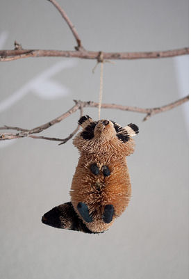 Stuffed toy raccoon decoration on a woodland creatures forest animals baby crib mobile