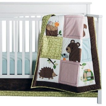 Woodland forest nursery theme ideas with hedgehogs bears baby deer bambi fox owl wildlife green brown with a rustic patchwork crib quilt