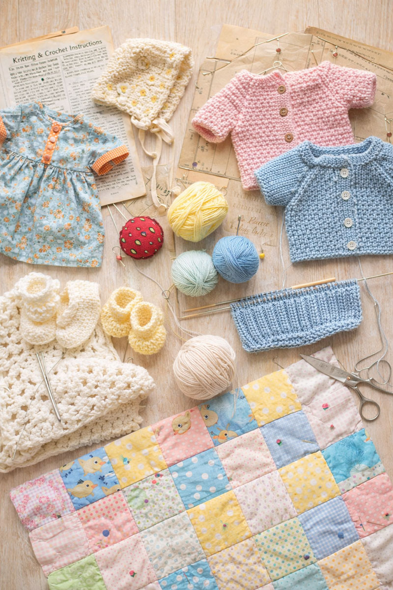 Handmade baby pattern projects including sewing, crochet, knitting, and quilt pieces laid out for inspiration