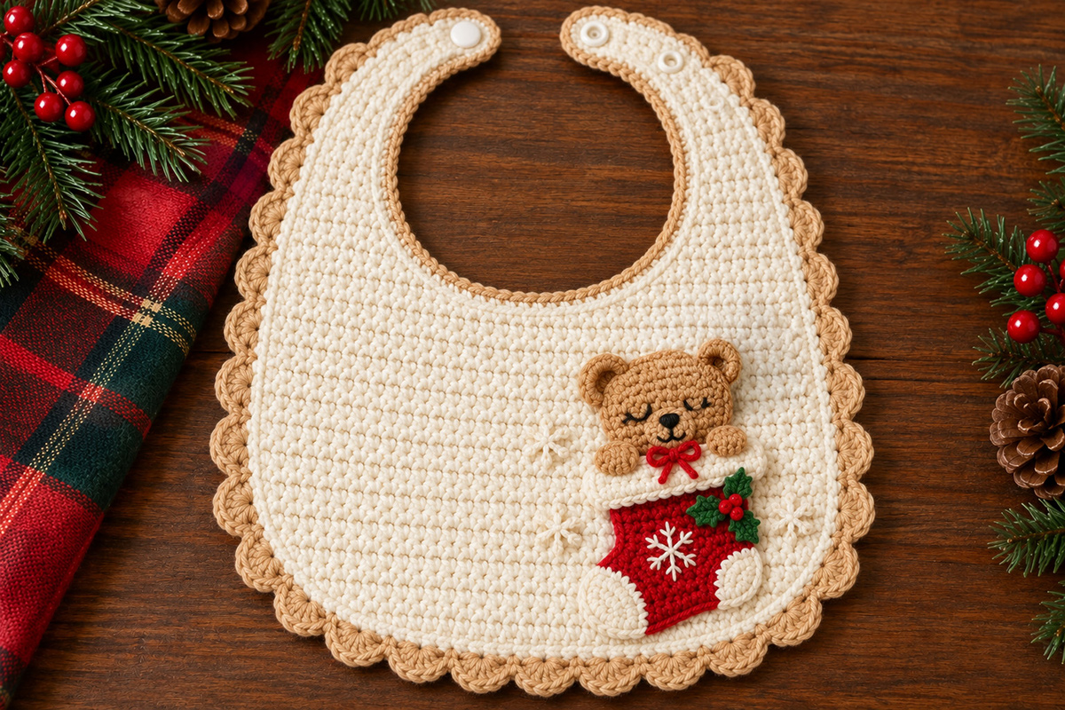 Free crochet Christmas teddy bear bib pattern with buff-brown teddy peeking from red stocking on a wide ivory scalloped baby bib decorated with holly and snowflakes