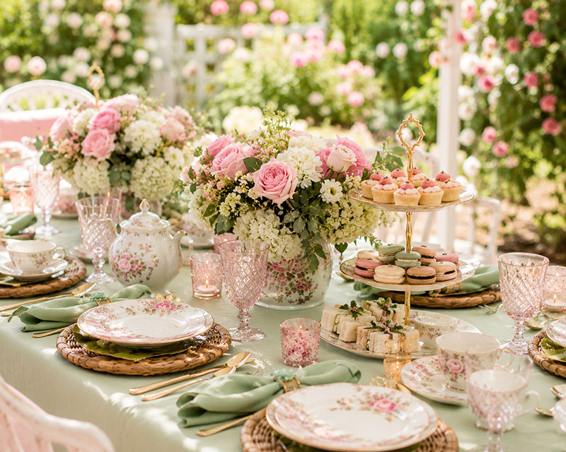 Garden tea party table setting with coordinated serving pieces and layered place settings