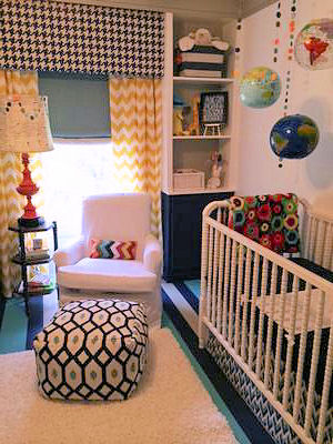 Baby boy nursery room decorated using a variety of popular fabric patterns including chevron window treatments