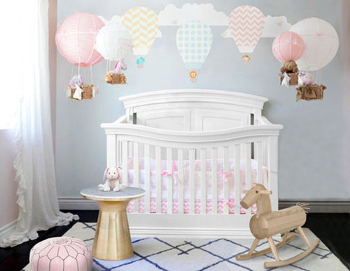 Hot air balloon baby nursery decorating ideas with decals and DIY hot air balloon crib mobiles in a baby girl nursery room