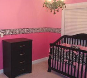 Baby girl hot pink and zebra print nursery bedding with black crib and wallpaper border