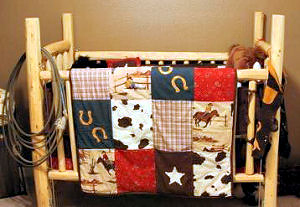 Homemade rustic baby crib made using logs for a baby boy's western cowboy baby nursery theme room.