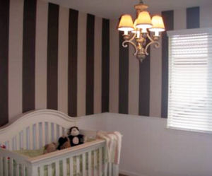 Baby girl nursery room with DIY pink and brown stripes painted on the wall